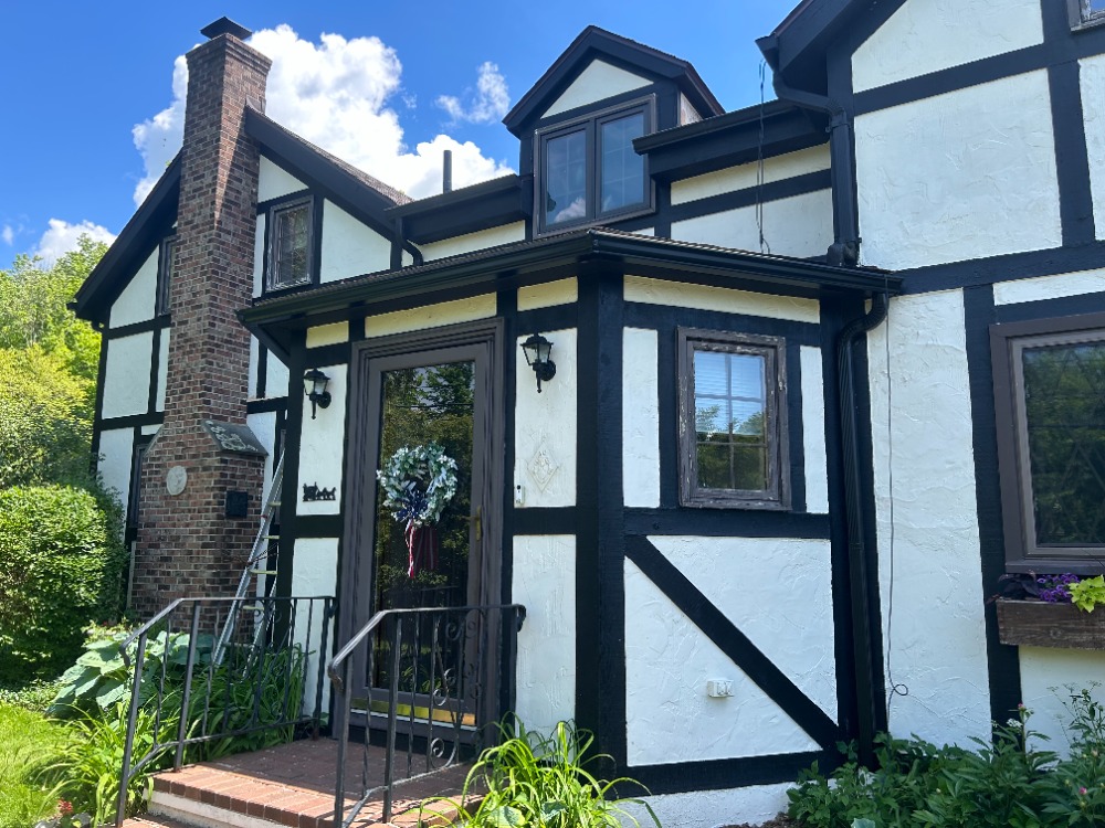 Seamless gutter installation on a Tudor-style Rochester home